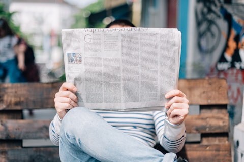 Newspaper and notebook on a reporter's desk