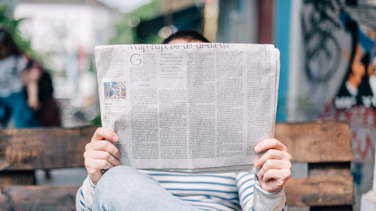 Journalist's desk with open notebook, pen, and recorder