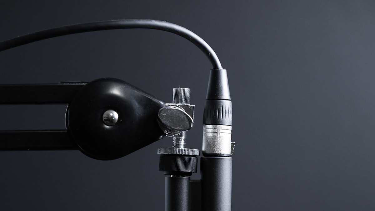 Podcast studio microphone on a warm desk lamp backdrop